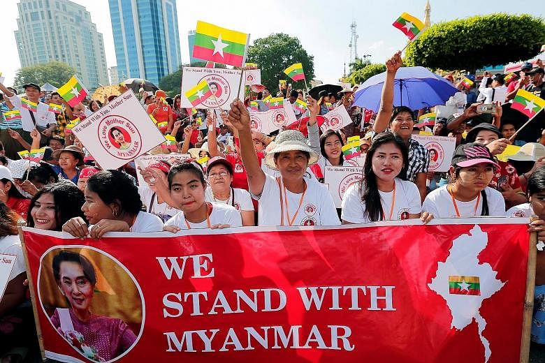 People rallying in support of Myanmar State Counsellor Aung San Suu Kyi in Yangon on Sunday, before her departure for the International Court of Justice in the Netherlands to face accusations of genocide.