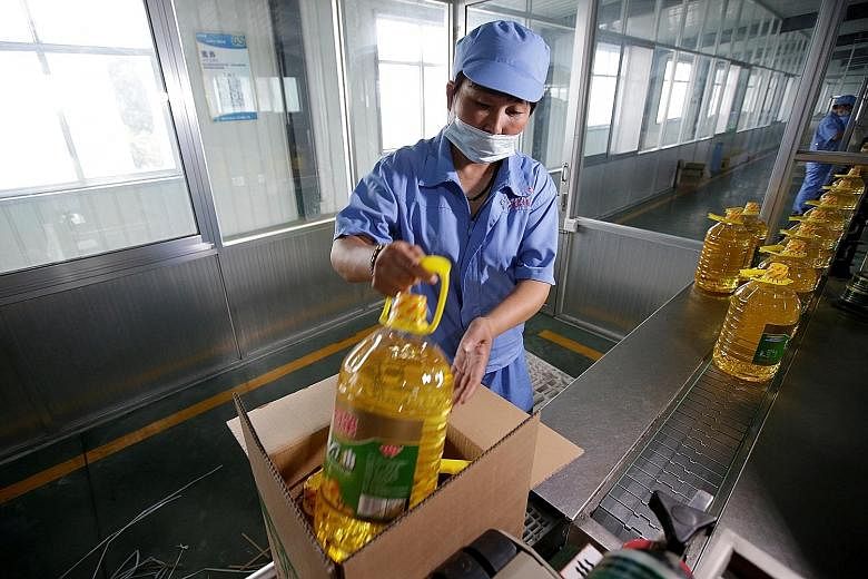 A soya bean oil factory in China. Amid a trade war between the world's two largest economies, China yesterday said it will offer a tariff waiver to "some" imports of US soya bean and pork - a sign that a trade deal could still be inked. 