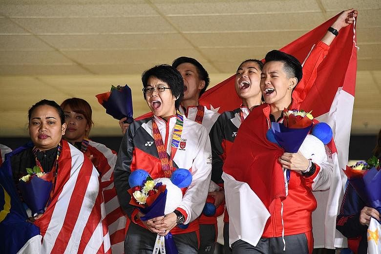 Singapore bowlers (from right), Shayna Ng, Daphne Tan, New Hui Fen and Cherie Tan celebrating their gold medal yesterday. It was the first SEA Games women's team gold for Singapore since 2011.