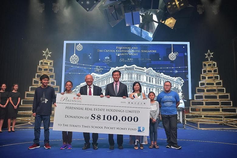 Education Minister Ong Ye Kung flanked by Mr Pua Seck Guan, director and chief executive of Perennial Real Estate Holdings, and Ms Tan Bee Heong, general manager of The Straits Times School Pocket Money Fund, with beneficiaries of the fund at Capitol