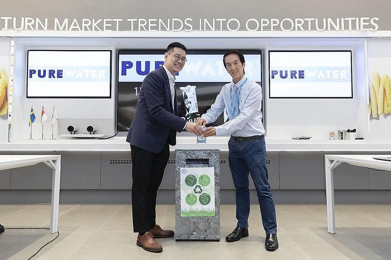 Polar Water managing director Chew Thye Chuan (right) and Mr David Tan, key account director of Tetra Pak Malaysia, Singapore, the Philippines and Indonesia, recycling a used Purewater carton. PHOTO: POLAR WATER DISTRIBUTOR