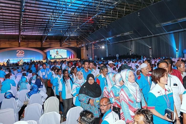 Parti Keadilan Rakyat members allied to deputy president Azmin Ali leaving the event hall where the congress was held yesterday. In a press conference after the walkout, Mr Azmin said party president Anwar Ibrahim's policy address paved the way for d
