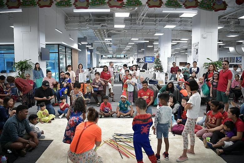 Children of The Straits Times staff got the opportunity to see where their parents work, as well as enjoy treats such as candy floss, popcorn and ice cream from a pushcart, at the year-end celebration and Christmas party yesterday. There was also a b