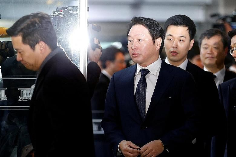 SK Group chairman Chey Tae-won arriving in Seoul to attend a hearing at the National Assembly in December 2016. His wife Roh Soh-yeong is now demanding $1.6 billion worth of shares held by him in the company as part of the settlement, in what is bill