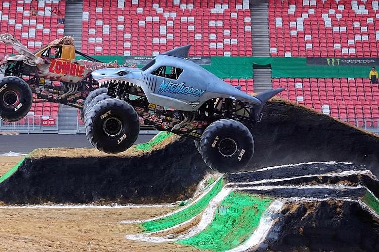The Megalodon, driven by Alex Blackwell, and Zombie, driven by Bari Musawwi, racing against each other during the Monster Jam Drivers' practice session on Friday. Some of the world's best monster truck drivers were in Singapore to show off their skil
