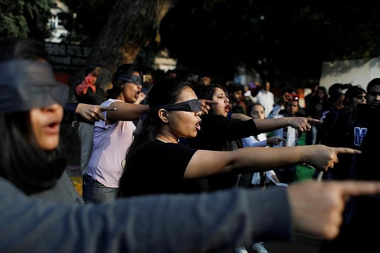 People wearing blindfolds taking part in a protest yesterday to show their solidarity with rape victims and oppose violence against women in India. PHOTO: REUTERS