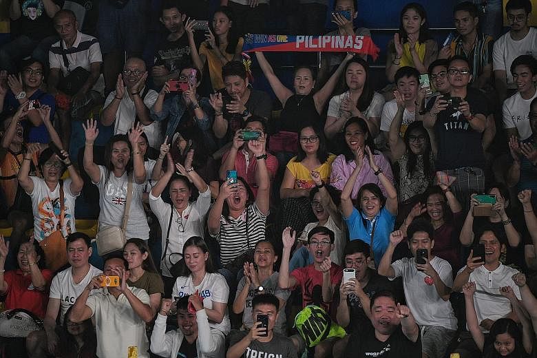 Spectators cheering during the badminton matches at the Muntinlupa Sports Complex in Manila on Thursday. ST PHOTO: MARK CHEONG
