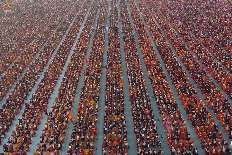 Some 30,000 monks lining up for alms during the alms-giving ceremony yesterday morning next to an airport in Mandalay, Myanmar.