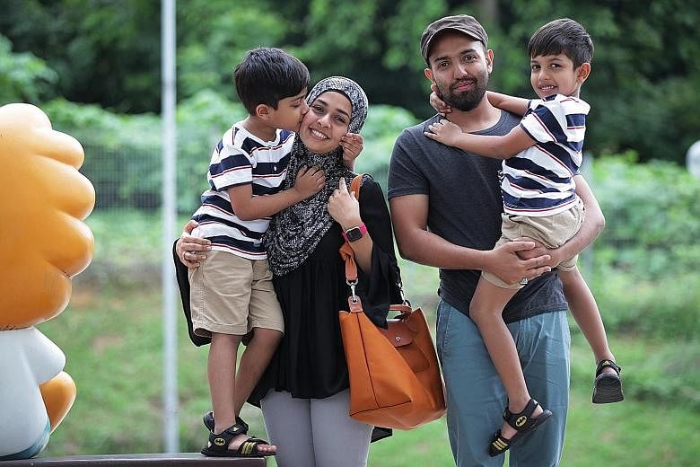 Housewife Aswin Jamee Mohamed Ameerdin and her husband, Mr Mohamed Azhar, with their sons, Ahmad Irfan (far left) and Ahmad Zishan, beneficiaries of the North West Community Development Council's bursary programme for pre-schoolers. ST PHOTO: GIN TAY