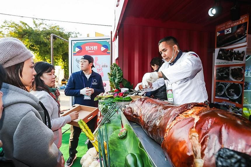 People waiting to buy lechon (roasted suckling pig) from a stall selling food from the Philippines at the Asean-Korea Food Street. Mr Oh Keo-don, Mayor of Busan, said the event was so popular that the South Korean city will hold it every year.