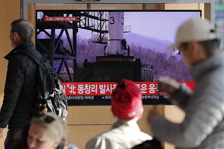 A TV news bulletin at a Seoul railway station yesterday showing a file image as it reported on North Korea's announcement that it had carried out a "very important test" at the Sohae Satellite Launching Ground, a site that has been used to launch sat