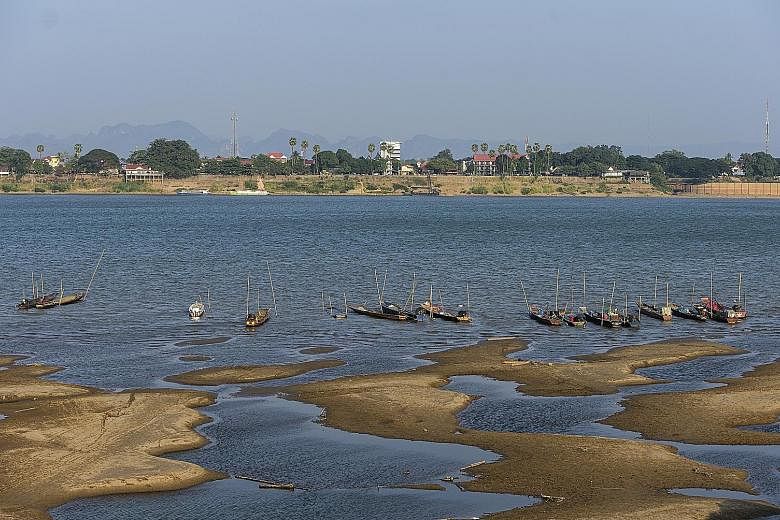 Fishing boats mooring last Wednesday in the Mekong River, which has turned blue instead of its usual muddy colour, in Nakhon Phanom province, north-eastern Thailand. Experts say the aquamarine colour may beguile tourists but it indicates a problem ca