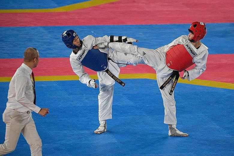 Singapore's Ng Ming Wei (right) being outfought 27-14 by Thailand's Ramnarong Sawekwiharee in the men's kyorugi (sparring) Under-58kg final.