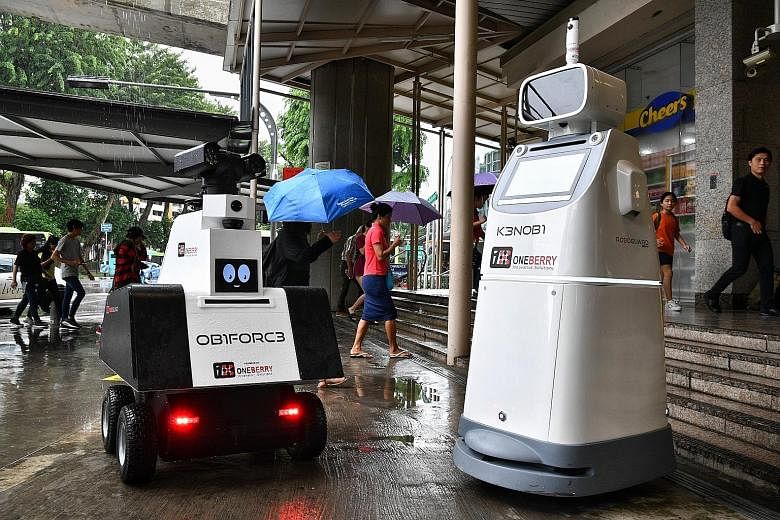 The robots - the OB1FORC3 and the K3NOBI models - are equipped with intelligent surveillance cameras, sensors and video analytics capabilities. ST PHOTO: CHONG JUN LIANG