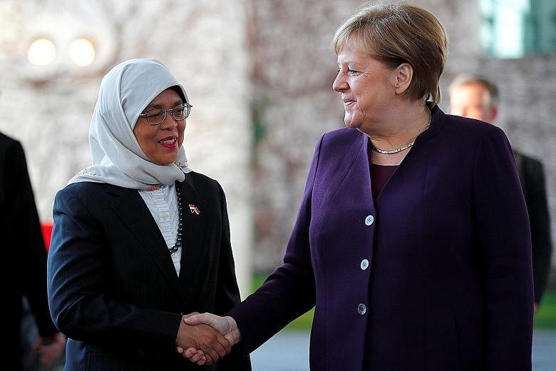 President Halimah Yacob being welcomed by German Chancellor Angela Merkel at the Federal Chancellery in Berlin yesterday.