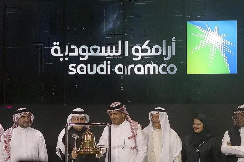 Saudi Arabia's state-owned oil giant Saudi Aramco and stock market officials at the official ceremony marking the debut of Aramco's initial public offering (IPO) on the Riyadh stock market yesterday. The Aramco shares leapt to 35.2 riyals (S$12.76) e