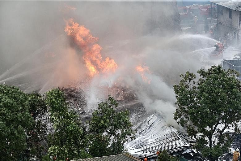 Firefighters using water jets to douse the flames. SCDF deployed 34 emergency vehicles and 130 firefighters. A total of 10 water jets and three unmanned firefighting machines were used to put out the fire. PHOTO: LIANHE ZAOBAO The scene after the fir