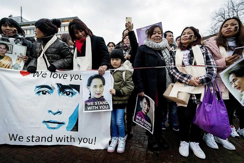 Demonstrators supporting Myanmar standing in front of the Peace Palace in The Hague yesterday. Myanmar's de facto leader Aung San Suu Kyi appeared before the International Court of Justice yesterday to defend her country against accusations of genoci