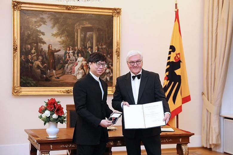 Singaporean conductor Wong Kah Chun receiving the Order of Merit of the Federal Republic of Germany from German President Frank-Walter Steinmeier at a state banquet on Tuesday.