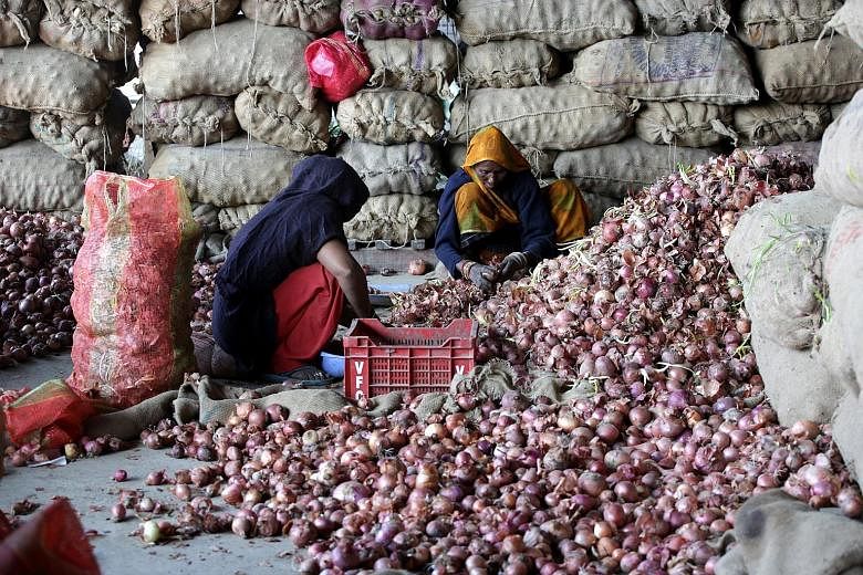 Labourers sorting onions at a market in Jammu last week. The Indian government has said the shortfall in onion stocks is 1.8 million tonnes.