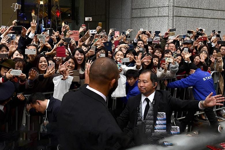 Fans in Tokyo waving at Japan captain Michael Leitch during a parade yesterday. The All Blacks finished third at the Japan World Cup. PHOTO: AGENCE FRANCE-PRESSE