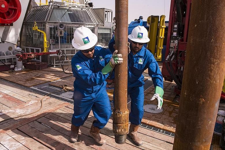 Saudi Aramco workers on an onshore rig at a undisclosed location in Saudi Arabia. While a 10 per cent jump in the stock on its Wednesday market debut was hailed by the Saudi government as a vindication of its long-sought valuation, support was largel
