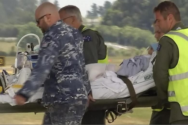 A video screengrab showing an injured victim of Monday's volcano eruption being taken to a Royal Australian Air Force plane in Hamilton, New Zealand, yesterday. New Zealand Prime Minister Jacinda Ardern said some injured Australians have been medical