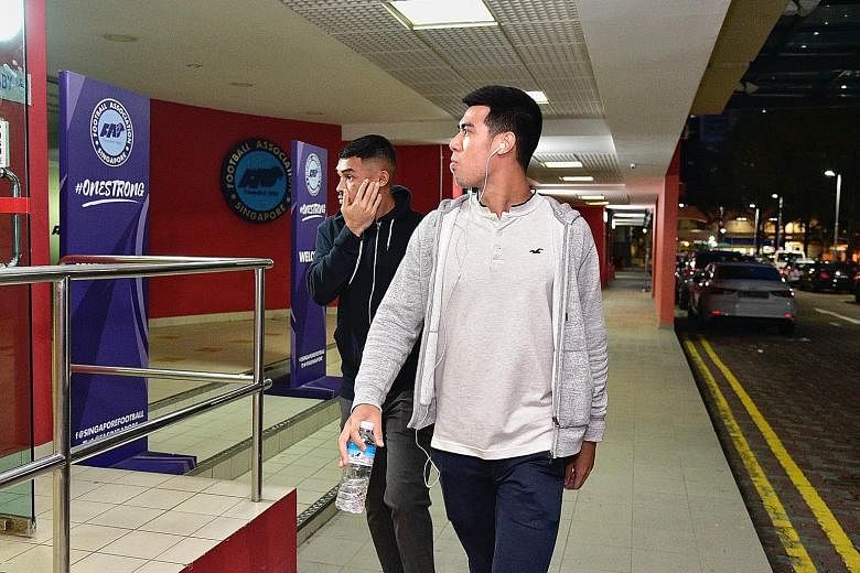 Zharfan Rohaizad and Lionel Tan entering the FAS headquarters at Jalan Besar Stadium on Wednesday night for the disciplinary hearing, which has been adjourned for "procedural issues" to be settled. ST PHOTO: DESMOND WEE