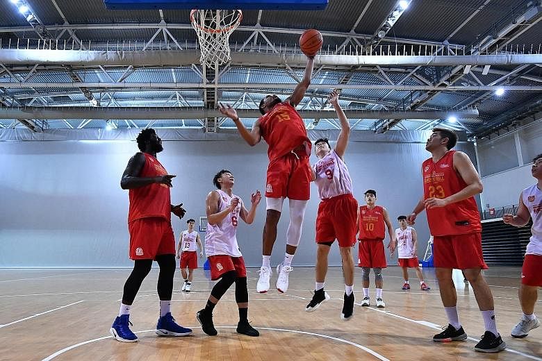 Xavier Alexander going up for a basket in training as Anthony McClain and Delvin Goh watch. The Slingers reached the Finals in three of the last four seasons but lost them all.