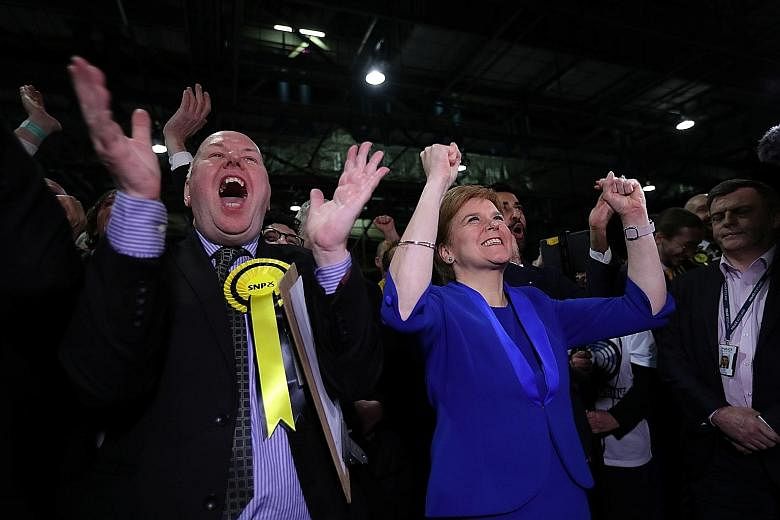 Scottish National Party leader Nicola Sturgeon cheering with supporters at a counting centre for the general election in Glasgow, Scotland, yesterday. Scottish nationalists won 48 of the 59 parliamentary seats in Scotland.