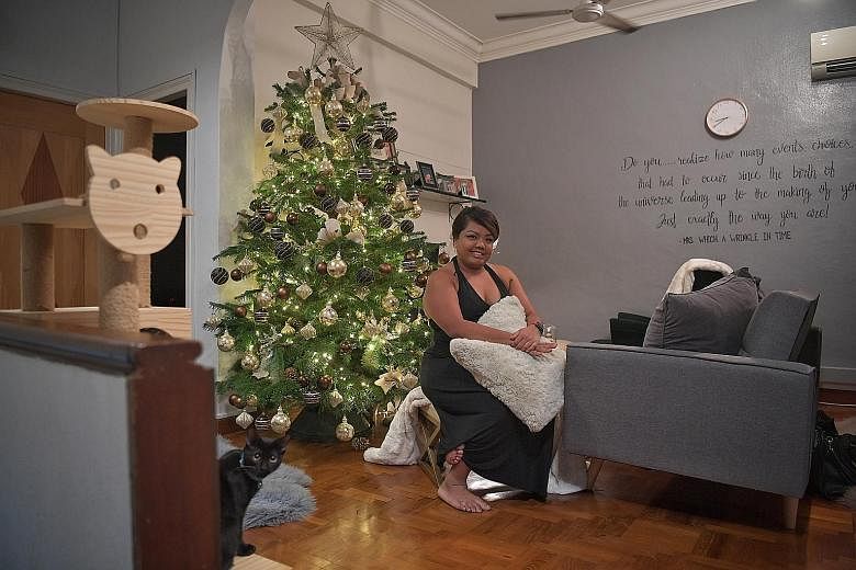 Events planner Rubina Tiyu decided on a muted colour scheme for her Christmas tree this year, with black, brown and gold baubles and beige lace ribbons. 