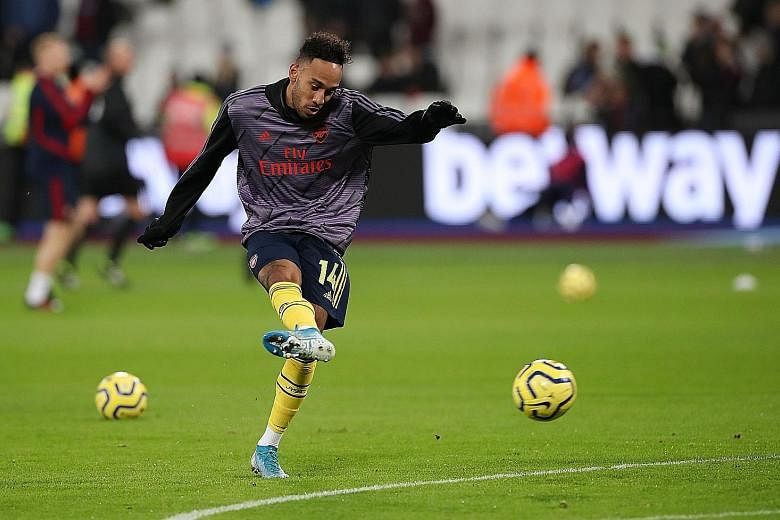 Pierre-Emerick Aubameyang warming up before the Premier League match against West Ham on Monday. He scored Arsenal's final goal in their 3-1 away win and is joint second in the scoring stakes.