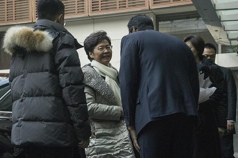 Hong Kong Chief Executive Carrie Lam arriving at a hotel in Beijing yesterday. She has said a Cabinet reshuffle was not an "immediate task" and she would focus on restoring law and order to Hong Kong.