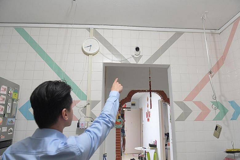 Mr Daniel See, 29, pointing to a closed-circuit television camera which was installed as instructed by the Community Dispute Resolution Tribunal to capture any noise and activity in his Bukit Panjang flat.