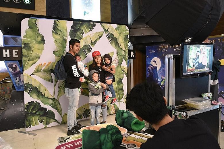 Ms Uswaton Hamid with her husband, Mr Muhammad Sairi, and their children, who were among the beneficiaries of the movie outing sponsored by Humming Flowers and Gifts.