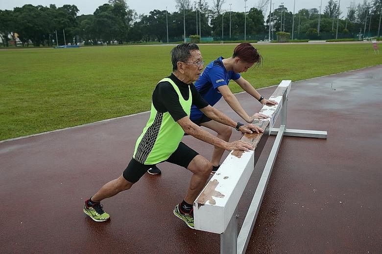 Kor Hong Fatt and grandson Aston Kor cooling down after a run. The older Kor, who suffered a heart attack 17 years ago, took up running seriously and has not looked back.