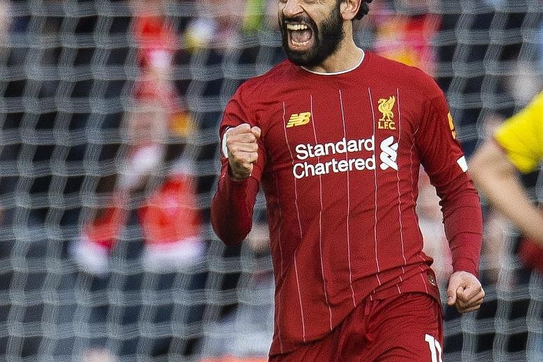 Liverpool's Mohamed Salah celebrating the first of his two goals during the 2-0 Premier League win over Watford at Anfield yesterday.