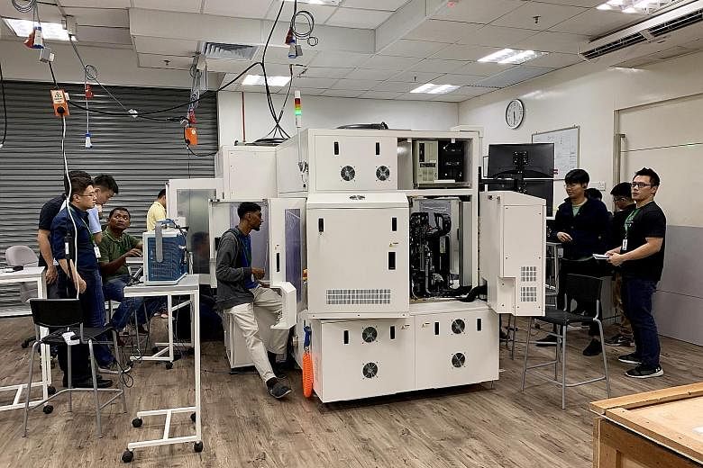 Above: Datuk Seri Wong Siew Hai, chairman of the American Malaysian Chamber of Commerce's electronics committee, says Penang needs to win the "talent war" to ensure investors stay. Left: Staff at high-technology equipment maker Pentamaster, which has