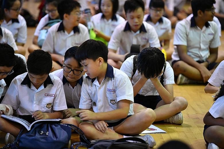 Pupils at Geylang Methodist School (Primary) waiting for their Primary School Leaving Examination results last year. By 2024, full subject-based banding will be rolled out to all secondary schools and students will no longer be streamed into Normal-E