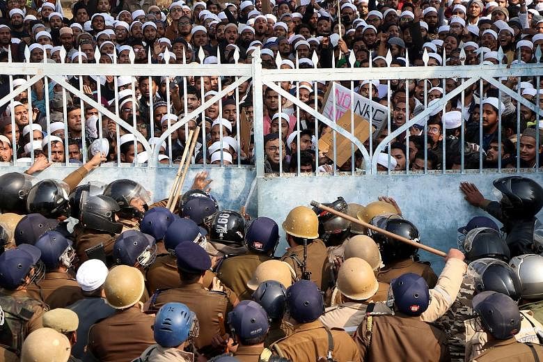 Students of an Islamic university in Lucknow in northern India clashing with police yesterday during a rally against the new law, which gives citizenship to non-Muslims who entered India illegally to flee religious persecution in several neighbouring