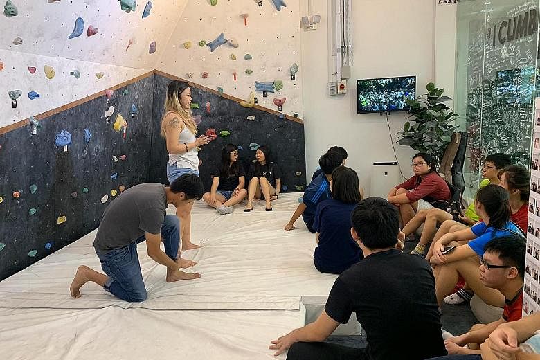 Limitless case worker Megan Tang briefing a group of young people during a climbing programme centred around character development in April. "Seeing them reach goals, even small ones, that they never thought they would be able to achieve, makes it wo