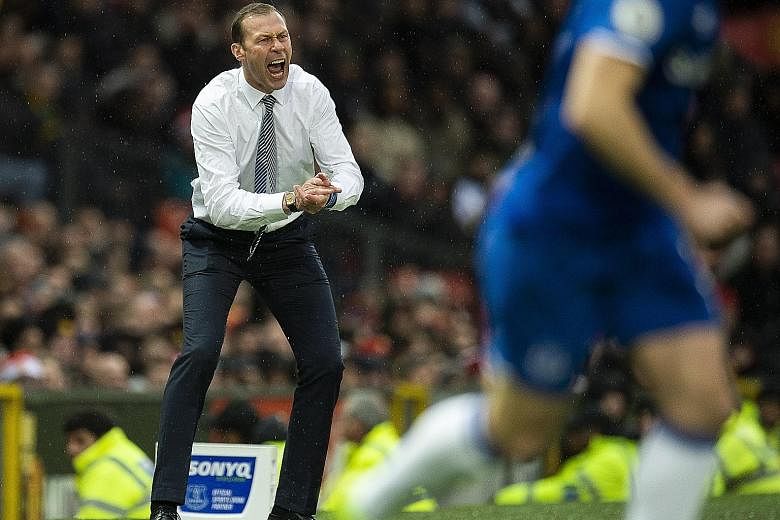 An animated Duncan Ferguson rousing his Everton players during the 1-1 draw at Old Trafford on Sunday. The Scot will likely be in charge of one more match before Carlo Ancelotti takes over, according to reports yesterday.
