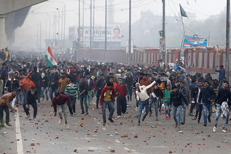 Indians protesting against a new citizenship law in Delhi yesterday. There were street protests in at least 25 cities across the country, and reports of the police in many cities using tear gas and rubber bullets, and beating students. PHOTO: REUTERS