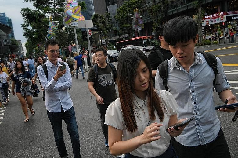The police were responding to rumours that pedestrians can be fined for using their phones while crossing the road. ST PHOTO: MARK CHEONG