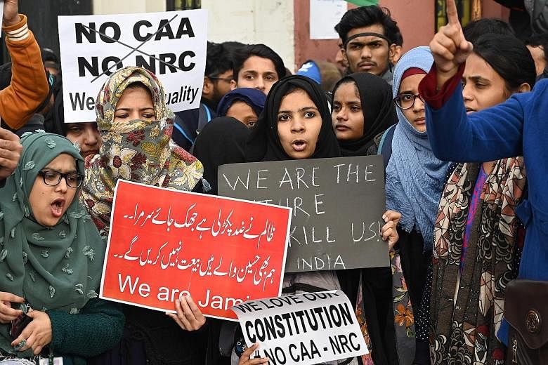 Students and supporters protesting over India's new citizenship law outside Jamia Millia Islamia university in New Delhi yesterday. University students across India have been leading a campaign to have the citizenship law overturned. PHOTO: AGENCE FR