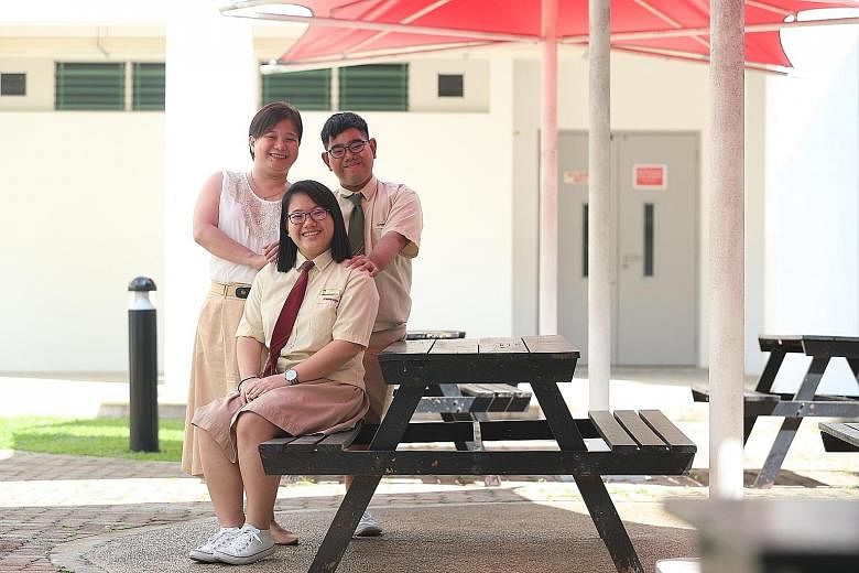 Siblings Jerlyn and Javier Loh, both Greenridge Secondary School students, with their mother Joanne Yap. Jerlyn had to power through migraines due to a genetic disorder, and take care of Javier, who had a kidney transplant, all while studying.