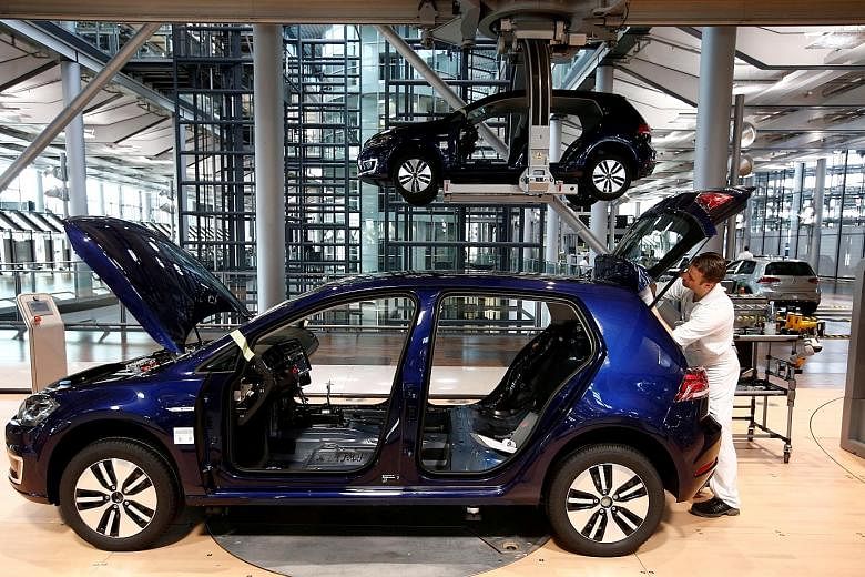 A Volkswagen production line in Dresden, Germany. Producing an electric engine requires fewer parts, so companies supplying components to auto manufacturers might be harder hit by the country's shift to electric mobility. PHOTO: REUTERS