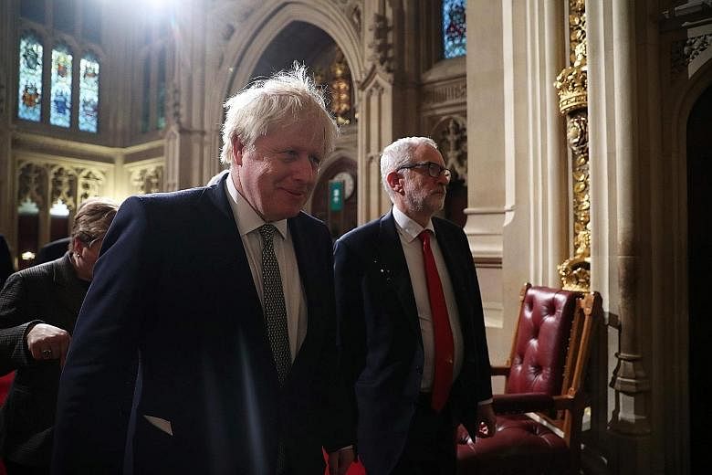 Prime Minister Boris Johnson (left) and Labour Party leader Jeremy Corbyn on the way to listen to Queen Elizabeth II's speech. PHOTO: AGENCE FRANCE-PRESSE Queen Elizabeth II and Prince Charles walking through the Royal Gallery before the monarch deli