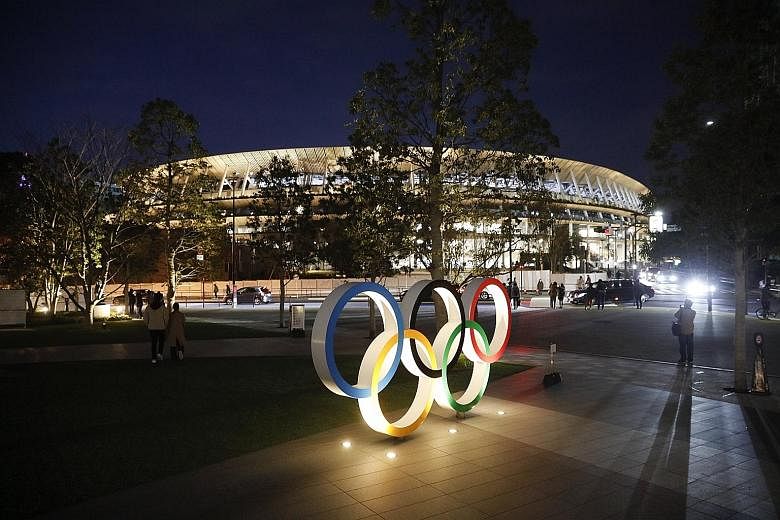 The Olympic rings in front of the new National Stadium in Tokyo. Due to overwhelming demand, most Japanese will not get to watch live events at the Games which they are helping to fund via taxes. 