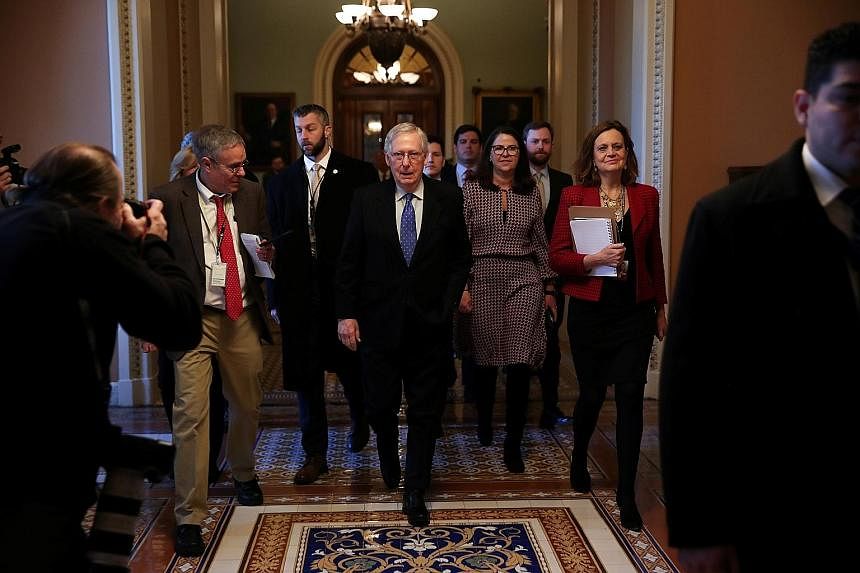 Senate Majority Leader Mitch McConnell returning to his office after a speech on the Senate floor of the Capitol in Washington on Thursday. He called the House process on the impeachment "slapdash". US House Speaker Nancy Pelosi, seen at the Capitol 